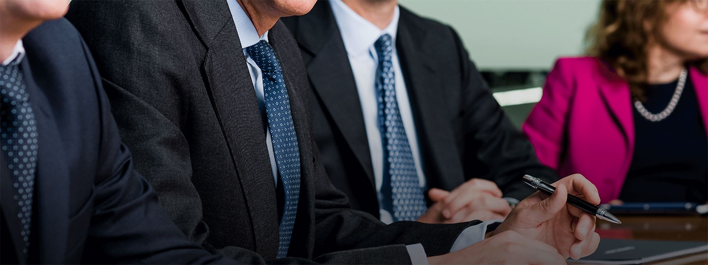 close up of business persons hand holding a pen.