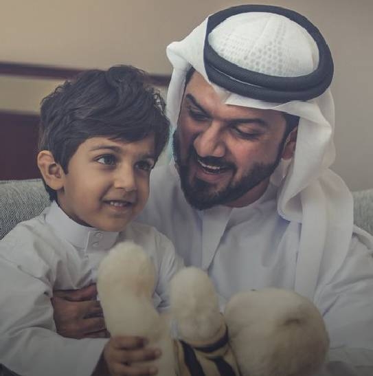 father and young son happily sat together.