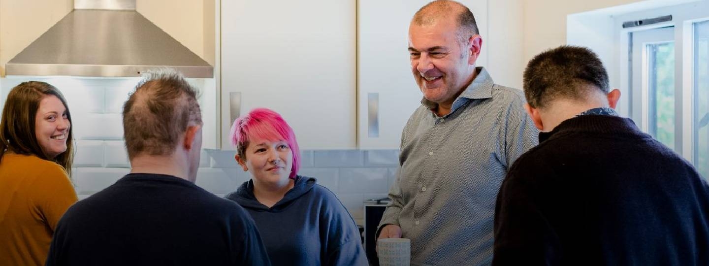 people chatting in a kitchen
