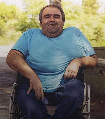 disabled man in wheelchair smiling.