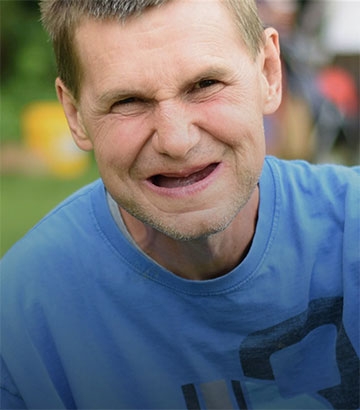 middle aged man smiling at camera.