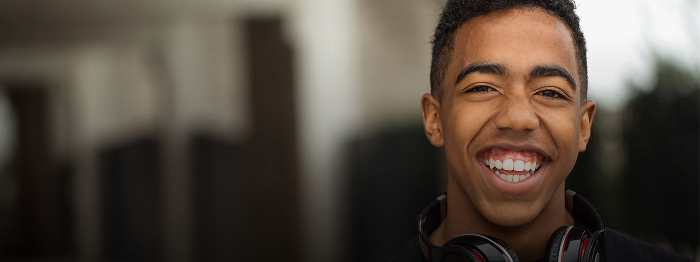 smiling teenage boy wearing headphones