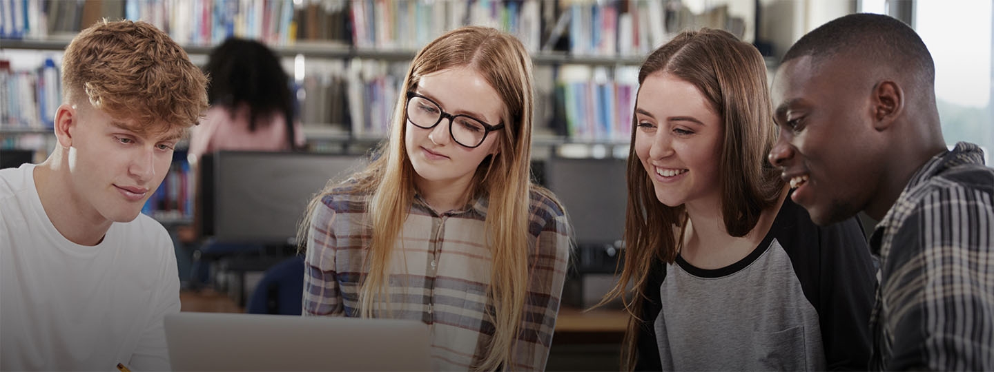 teenagers sitting around a laptop