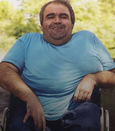 disabled man in wheelchair smiling.